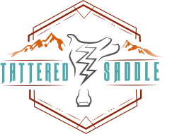 A stylized emblem featuring a central zigzag bolt with a goat skull silhouette, teal “Jittered” text, and orange mountain motif inside a geometric frame.